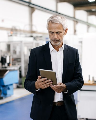 Manager using digital tablet in high tech company Manager using digital tablet in high tech company
