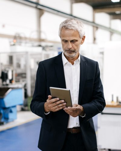 Manager using digital tablet in high tech company